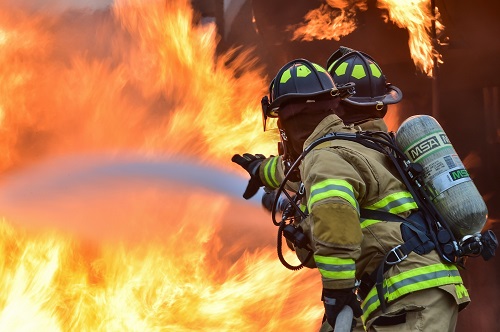 firefighters dousing a house fire